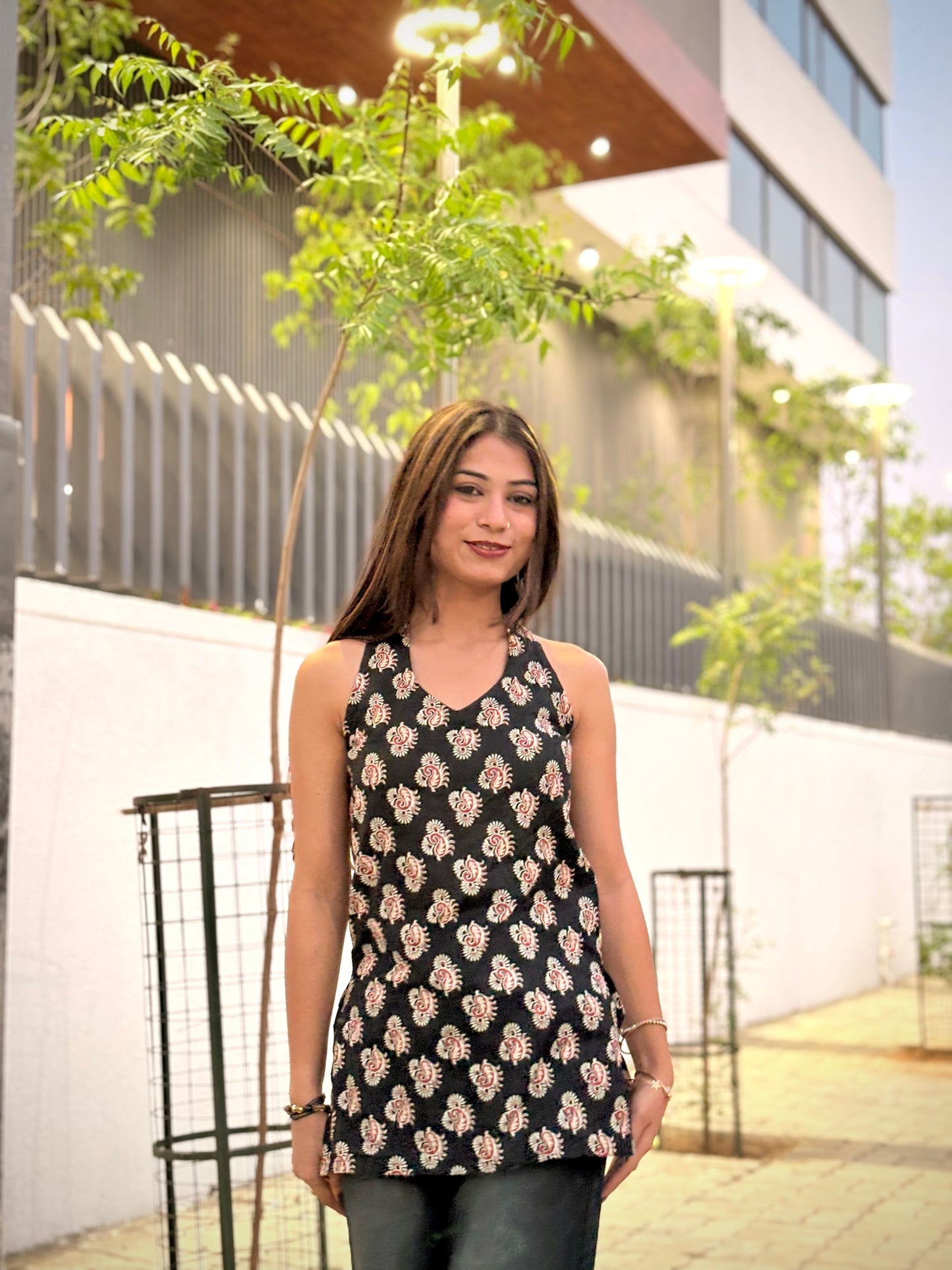 Girl wearing cream floral block-print tunic top with tie-back detail