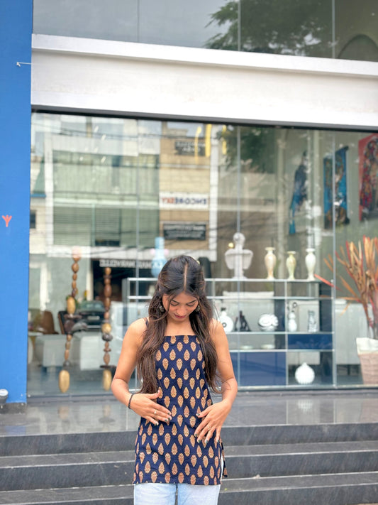 Girl wearing black paisley print halter top with tie-neck detail