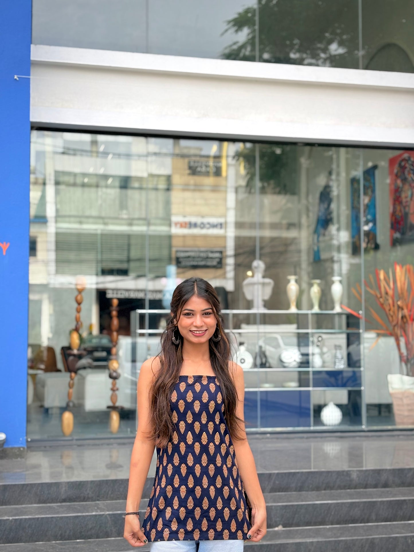 Girl wearing black paisley print halter top with tie-neck detail