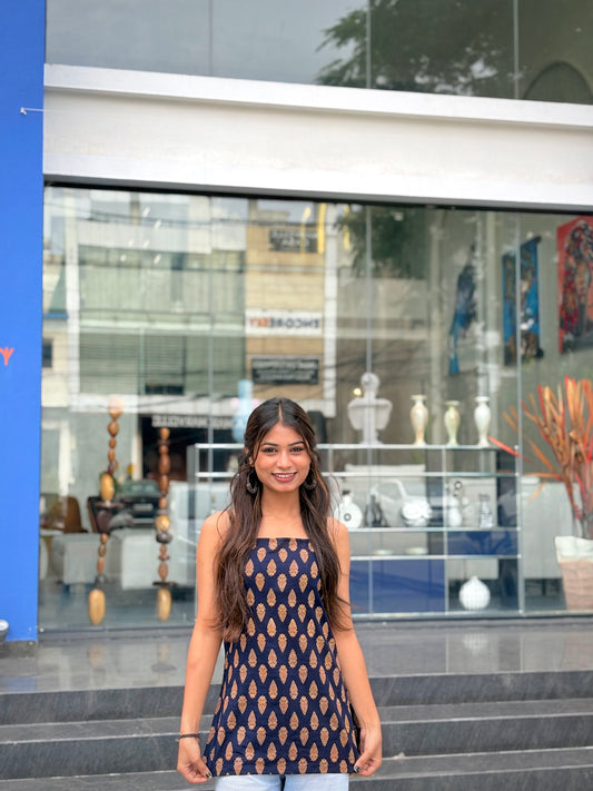 Girl wearing black paisley print halter top with tie-neck detail